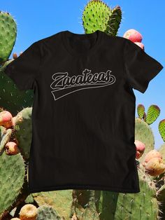 a black t - shirt with the word zacateas printed on it in front of cacti