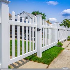 a white picket fence in front of a house