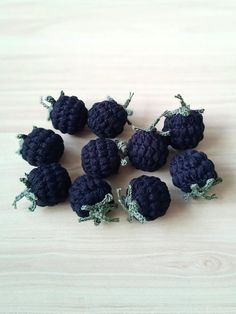 small crocheted blackberries sitting on top of a wooden table