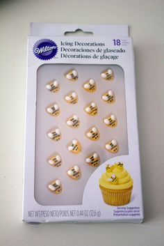 a package of decorated cupcakes with yellow frosting