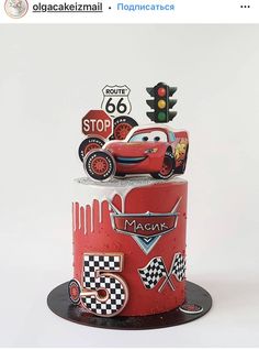 a red cake with cars on it and traffic lights