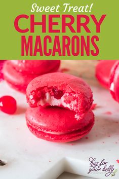 red velvet macarons are cut in half and sitting on a white cutting board