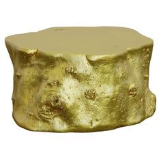 a gold colored stool that looks like it has been carved into the shape of a tree stump