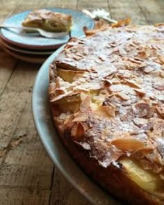 a cake sitting on top of a table covered in powdered sugar and toppings