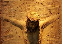 an image of jesus crucifix carved into the side of a wall