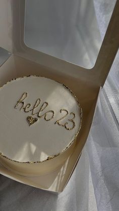 a cake in a box with the word hello 123 written on it's side