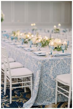 the table is set with blue and white linens