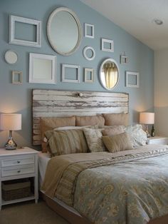 a bed room with a neatly made bed and many pictures on the wall above it