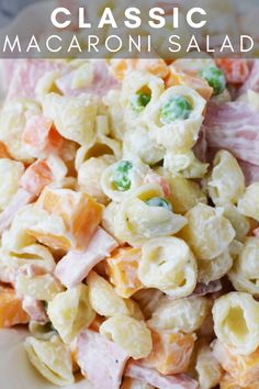 macaroni salad with ham and cheese in a bowl on a white plate text reads bbq side dish