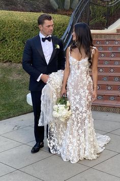 a man in a tuxedo standing next to a woman in a wedding dress