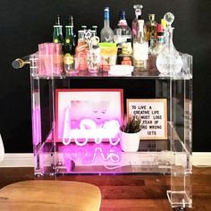 a bar cart filled with liquor bottles and glasses