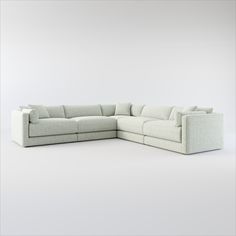 a white sectional couch sitting on top of a white floor