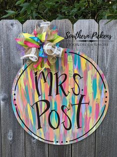 a wooden sign that says mrs post on the side of a fence with a bow