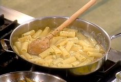 a pan filled with pasta and meat on top of a stove