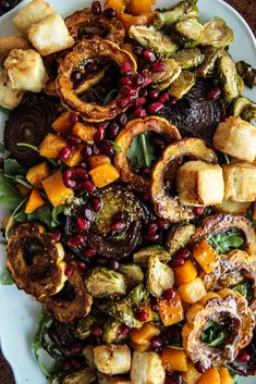 a white plate topped with lots of different types of food on top of a table