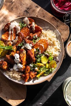 a bowl filled with food sitting on top of a wooden table