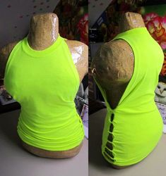 the mannequin is wearing a bright green shirt with holes in it's back