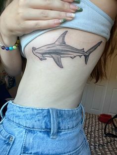 a woman with a shark tattoo on her stomach