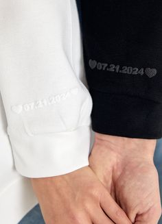 a person holding their hands together with the word love on it's sleeve and wrist