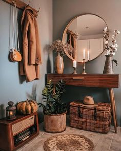 a living room filled with furniture and a large round mirror above the fireplace mantel