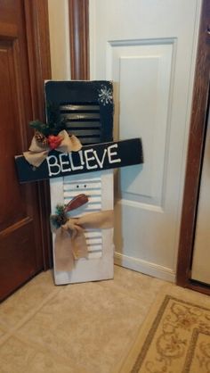 there is a sign that says believe in front of a door with ribbons on it