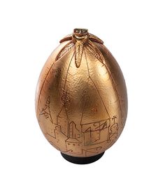 an egg with drawings on it sitting in front of a white background