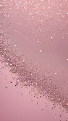 the water is pink and has small bubbles on it, as well as glitters