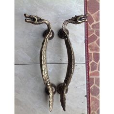 a pair of metal handles on a tile wall