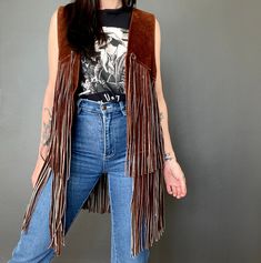 1970s suede fringed vest *Beautiful brown color.  *Thick heavy suede *Fringed *open front *Good but used vintage condition. Shows signs of age and wear but otherwise in really good condition. ERA: 1970s LABEL: None SIZE: Would fit a size L-XL (please check measurements) Shown on a size S FABRIC: Suede Measurements are taken flat and must be doubled: Chest: 52-57 cm x 2 Length (fringe not included): 55 cm Length (fringe included): 86 cm If you have any questions regarding this item please contact Suede Fringe Vest, Western Vest, Western Brown, Fringe Vest, Suede Fringe, Vest Outfits, Brown Suede, Womens Vest, Western Outfits