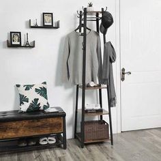 a room with a coat rack, bench and other items