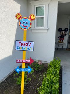 there is a sign that says the entrance to mickey mouse's clubhouse and some other signs