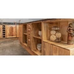 a kitchen with wooden cabinets and shelves filled with pots, pans and other items