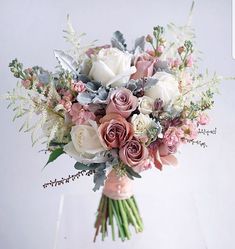 a bridal bouquet with pink and white flowers