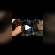 a video demonstrating how to use an electric stove top burner with the help of someone's hands