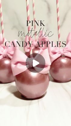 pink metallic candy apples with bows and candles in them on a white tablecloth, with text overlay reading pink metallic candy apples