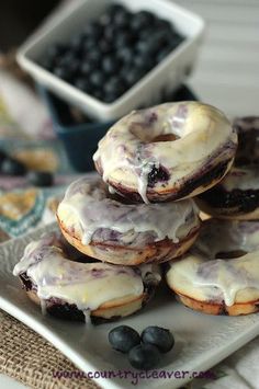 blueberry donuts with icing on a plate