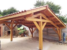 an outdoor covered area with a car parked under it