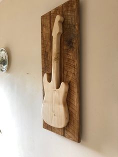 a wooden guitar hanging on the wall