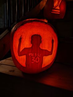 a pumpkin carved to look like a man with his arms crossed and the number 30 carved on it