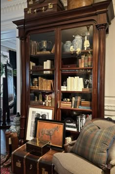 a living room filled with lots of furniture and books on top of a book shelf