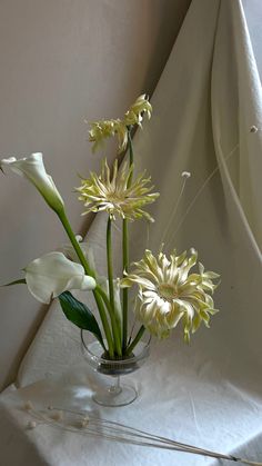 some white flowers are in a glass vase