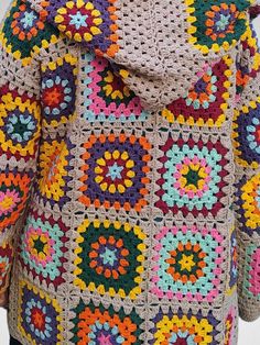 a crocheted jacket with multicolored squares on the shoulders and hood is shown