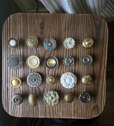 an assortment of knobs on a wooden tray