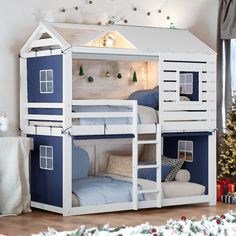 a white and blue bunk bed next to a christmas tree