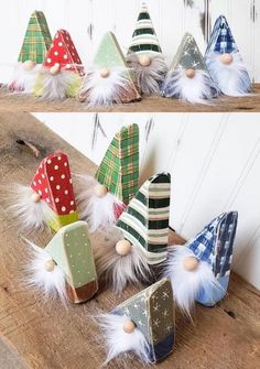 several different types of christmas hats are on top of a wooden table and one is decorated with white feathers