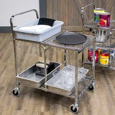 a kitchen cart with two pots and pans on it