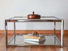 a table that has some books on it and a small animal figurine in the middle