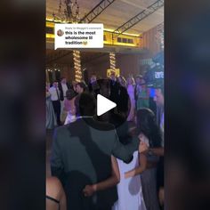 a group of people standing around each other in a room with one person on the dance floor