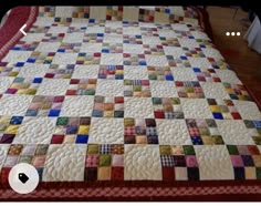 a bed with a colorful quilt on top of it