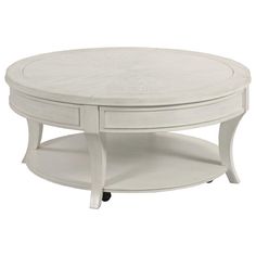 a white coffee table with two drawers on the bottom and one drawer open to reveal an oval